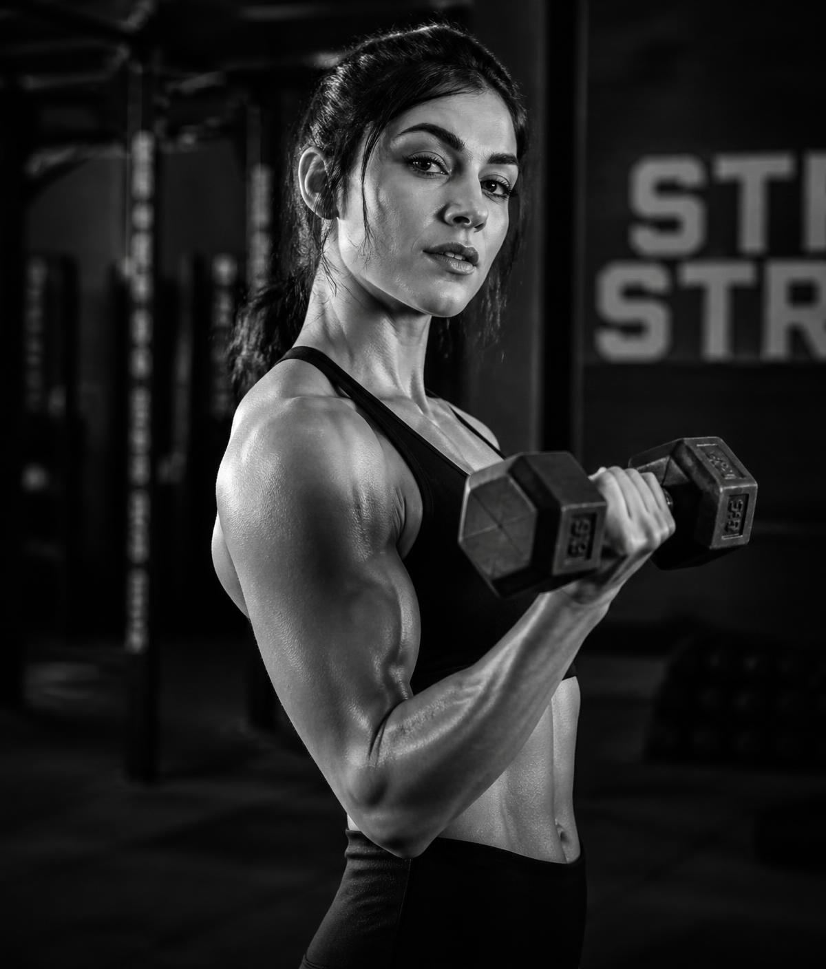 Woman training with a dumbbell at Lady Fitness